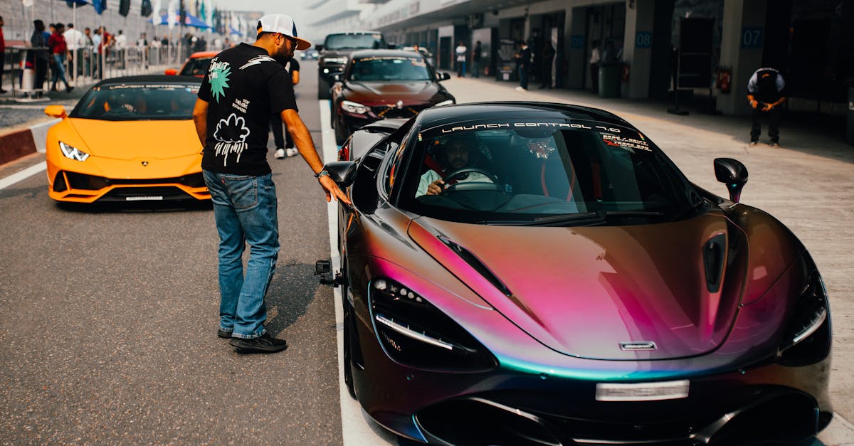 Dynamic scene featuring sports cars on a racing track in Greater Noida, India.