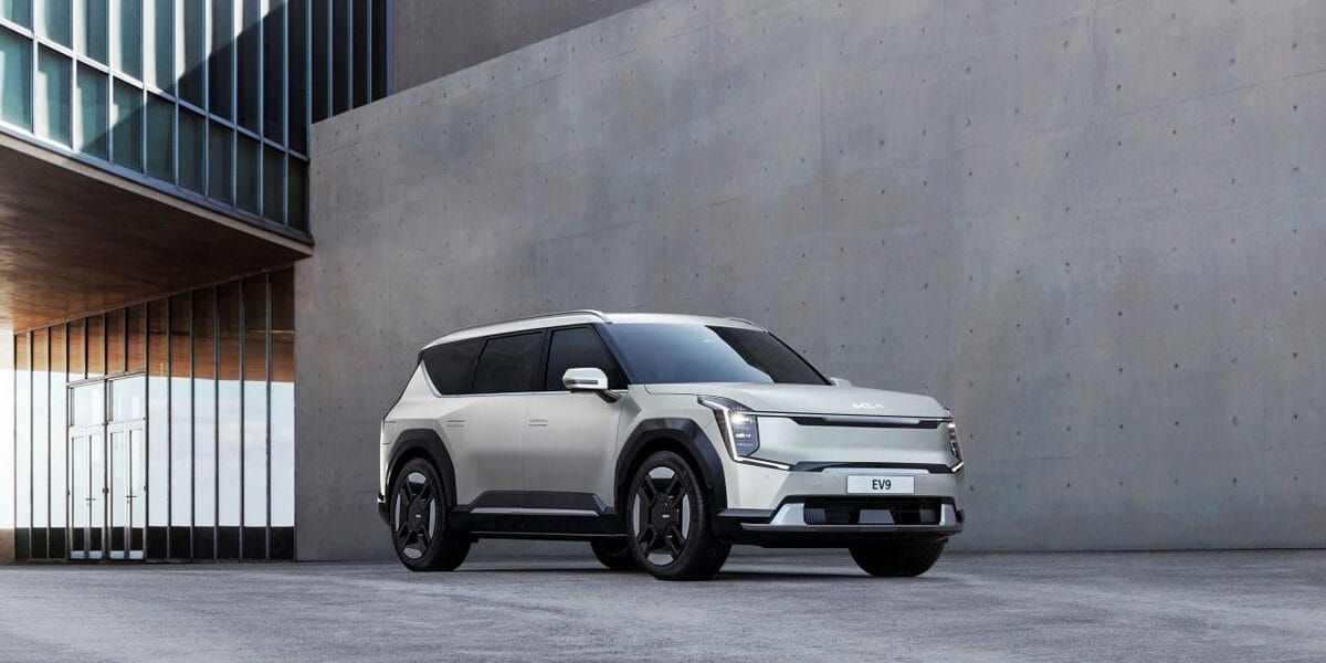 Kia EV9 electric SUV parked in an urban architectural environment, showcasing modern design.