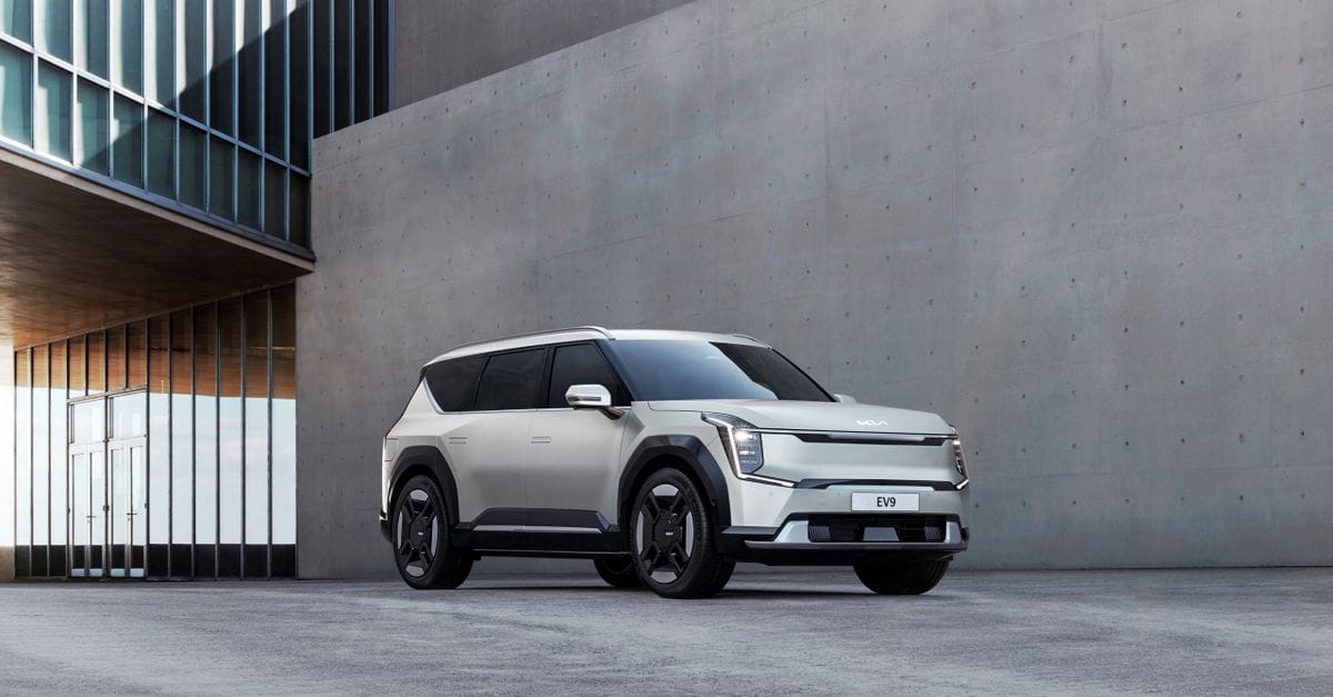 Kia EV9 electric SUV parked in an urban architectural environment, showcasing modern design.