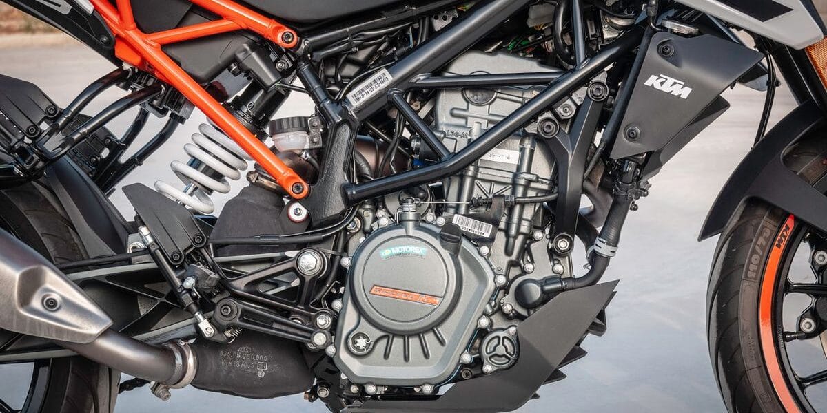 Detailed view of a KTM motorcycle engine showcasing design and machinery outdoors.