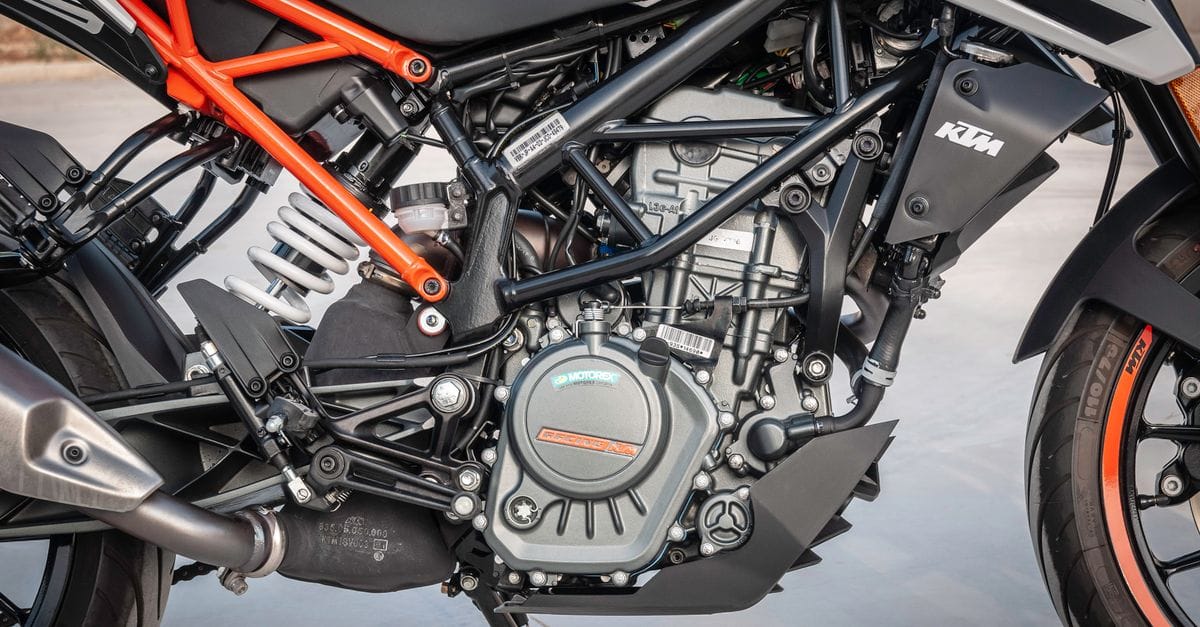 Detailed view of a KTM motorcycle engine showcasing design and machinery outdoors.