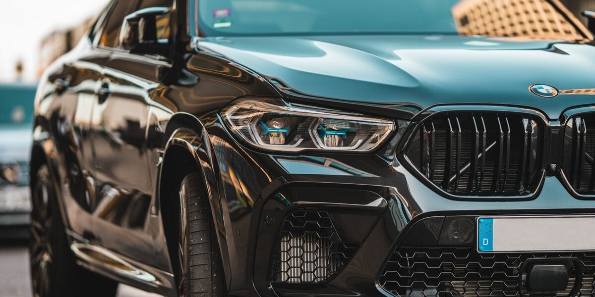 Close-up of a sleek black BMW parked on a city street in Berlin, displaying modern automotive design.