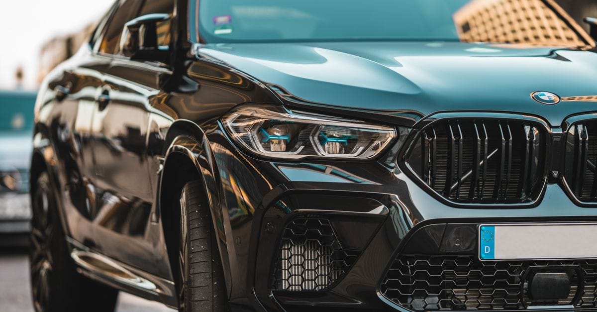 Close-up of a sleek black BMW parked on a city street in Berlin, displaying modern automotive design.