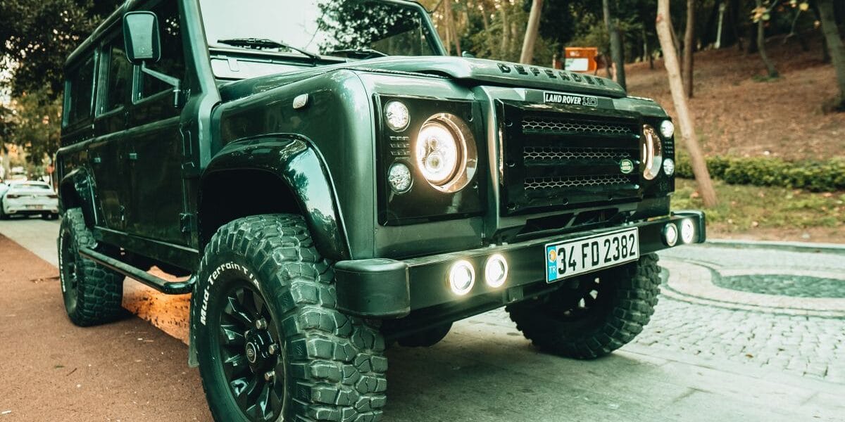 A rugged Land Rover Defender SUV parked on a street in Istanbul, showcasing its robust design.