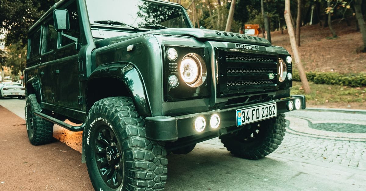 A rugged Land Rover Defender SUV parked on a street in Istanbul, showcasing its robust design.
