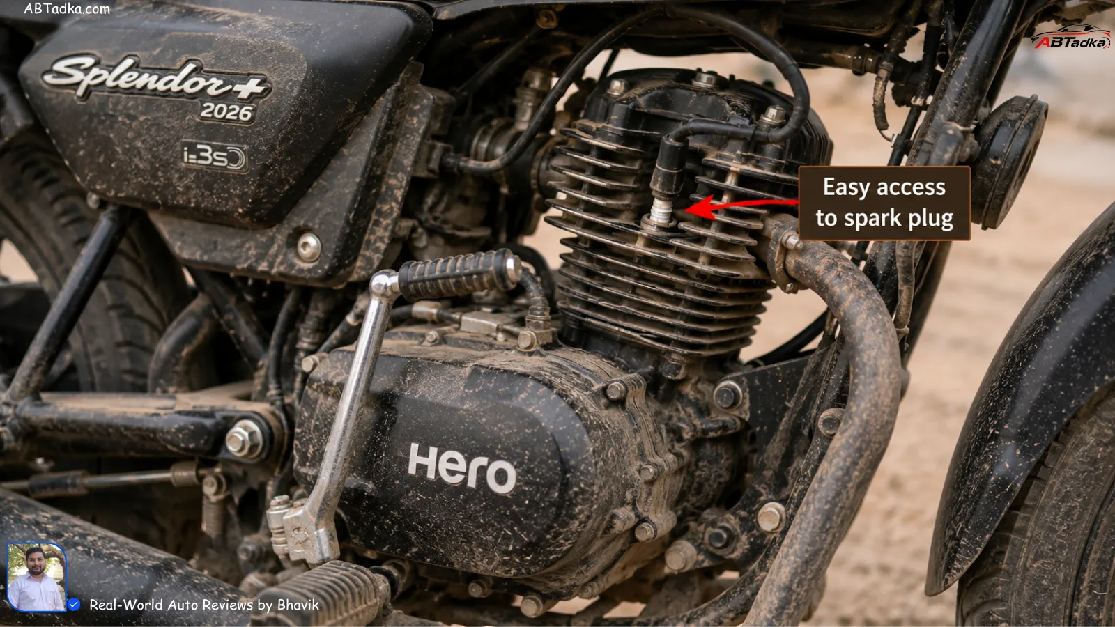 Close-up of Hero Splendor Plus 2026 engine covered in fine Gujarat road dust, showing simple air-cooled design with easy access to spark plug