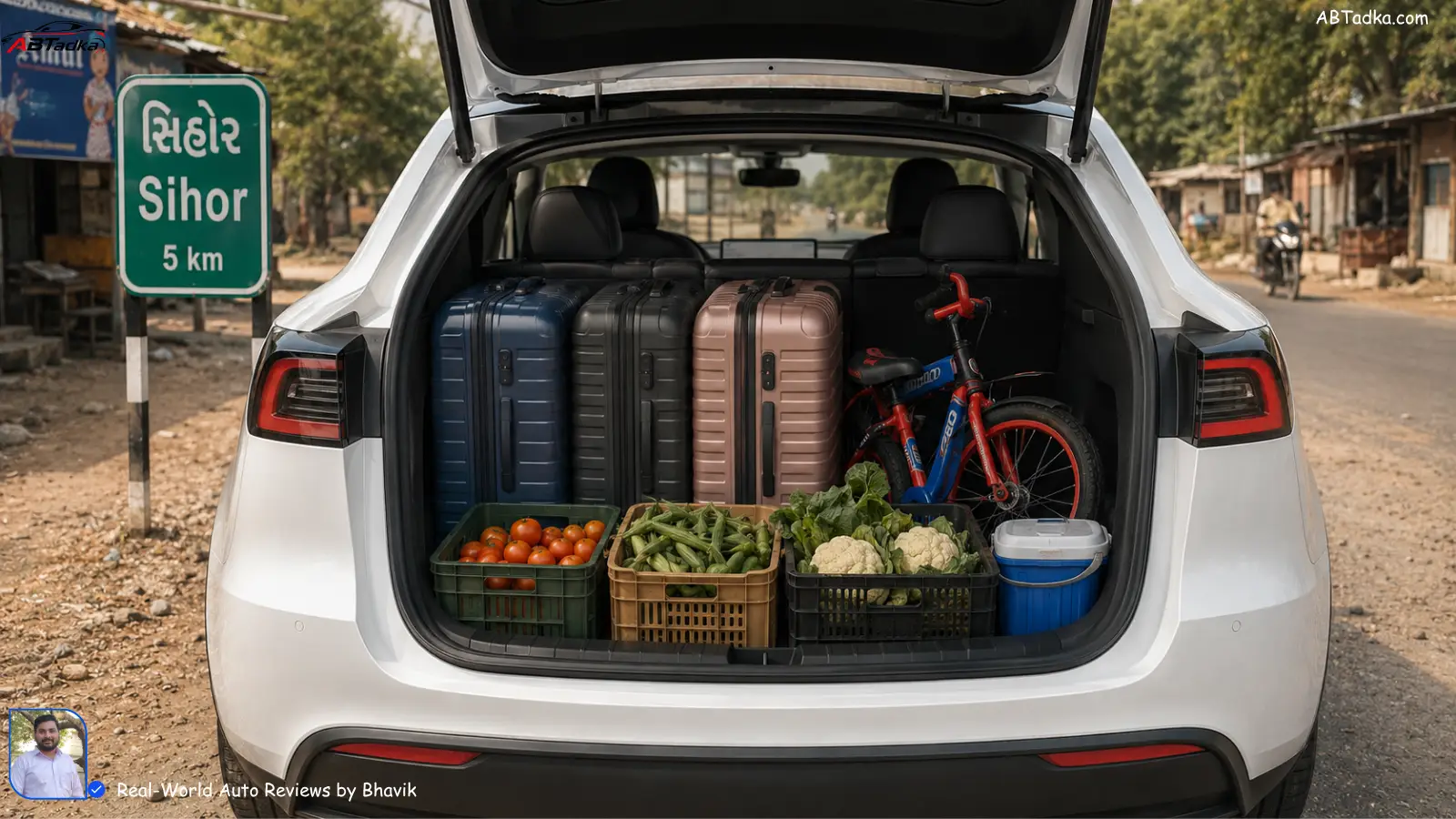 Tesla Model Y boot loaded with 3 large suitcases, vegetable crates, and a child’s bicycle showing practical family space for Indian road trips Tesla Model Y vs Model 3